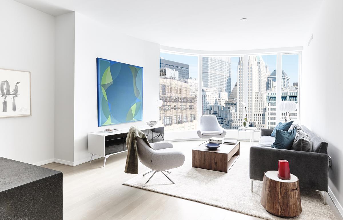 50 West St 17-A New York, New York Morning light splashes this spacious two-bedroom, two-and-a-half-bath home with eastern exposure. The chefs kitchen features custom stained walnut cabinetry, granite countertops, and a waterfall island. First-in-class appliances from Miele and Sub-Zero include two wall mounted convection ovens, gas cooktop, refrigerator, freezer, wine refrigerator, dishwasher and a range hood that vents directly to the outside. The en-suite five fixture master bath features a floating, backlit marble vanity, radiant floor heating, Hansgrohe polished chrome fixtures, an electronic Toto toilet with built-in bidet, a stall shower and a separate deep soaking tub. The second bath and powder room both include marble wet walls and flooring as well as custom vanities. Please allow 24 hour notice before viewing.